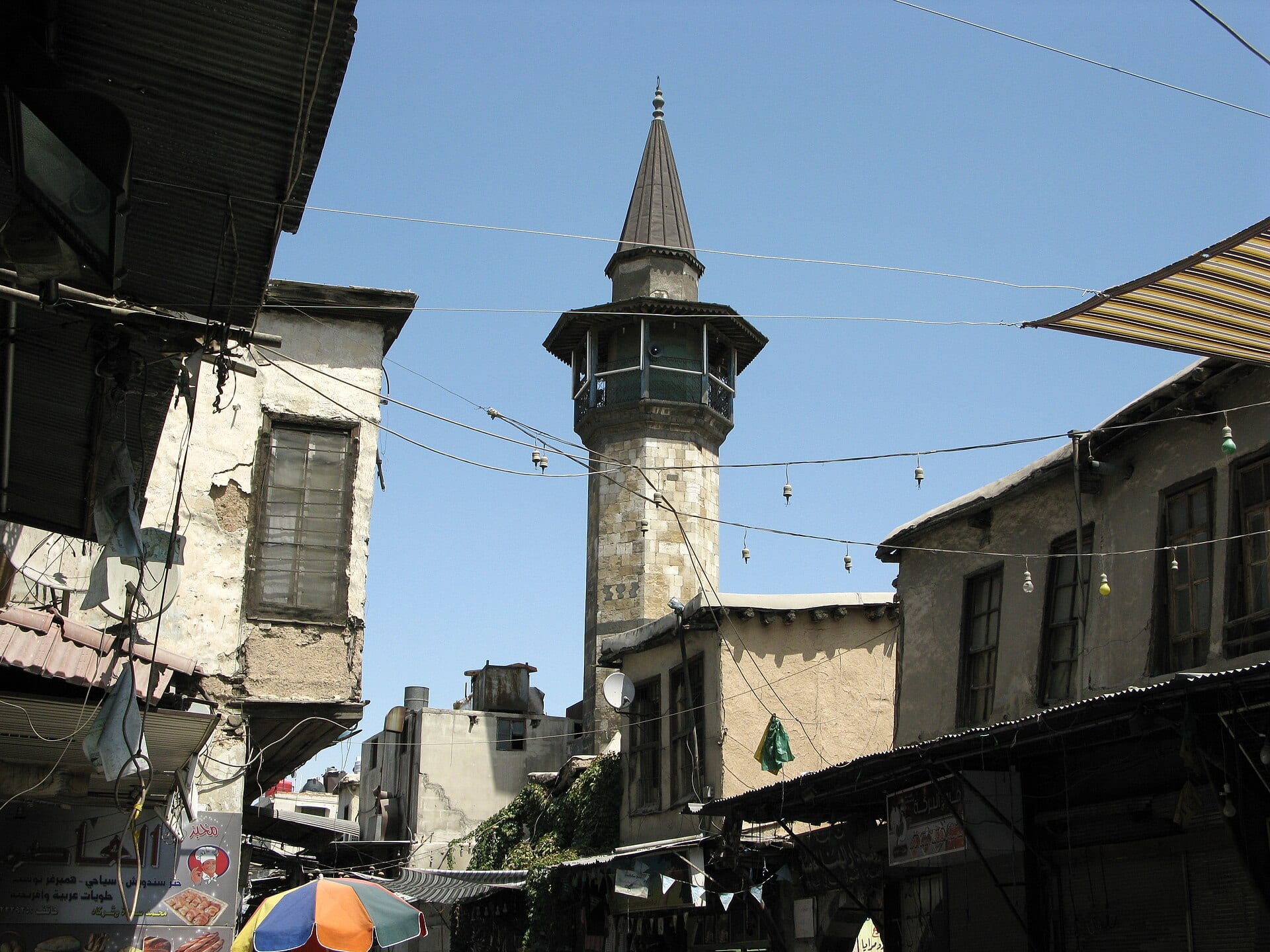 An old mosque minaret in Damascus rising above the surrounding roofs.