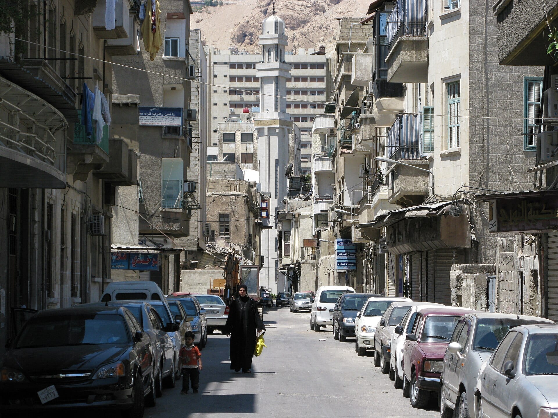 People going about an ordinary afternoon on a Damascus street.