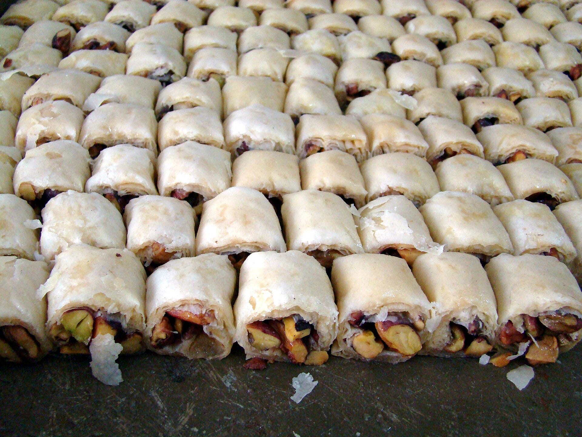 Trays of baklava stacked in the window of a Damascus sweet shop.