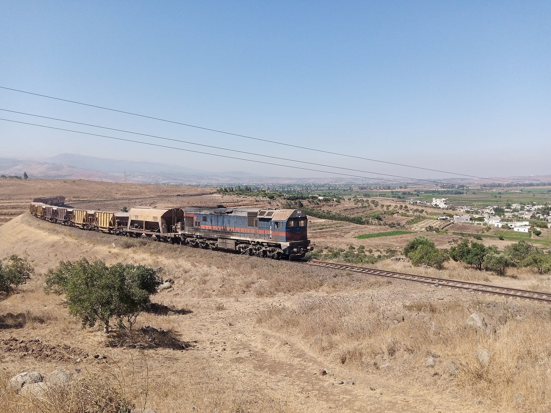 A phosphate freight train crossing open country near Homs.